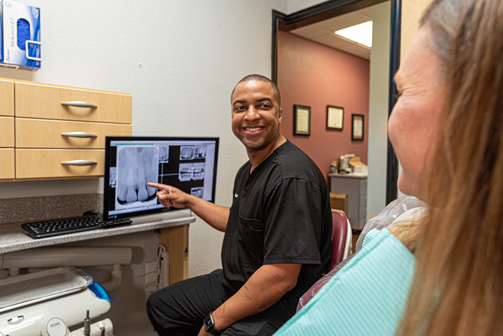 Dr. Carmichael discussing wisdom teeth removal in watauga with a patient